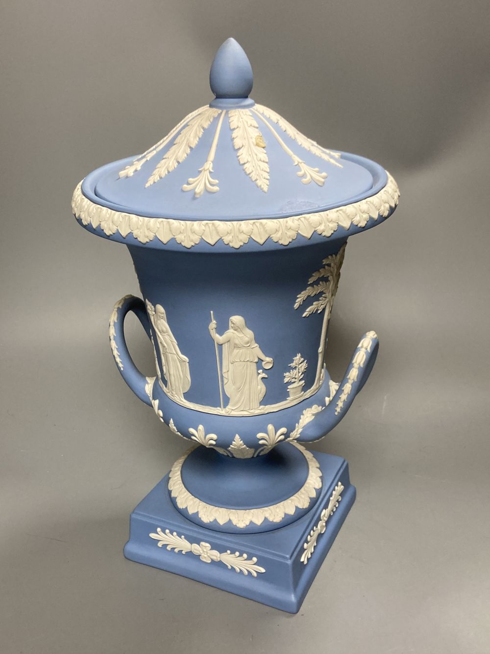 A 20th century Wedgwood light blue jasperware two-handled campagna-shaped urn and cover,